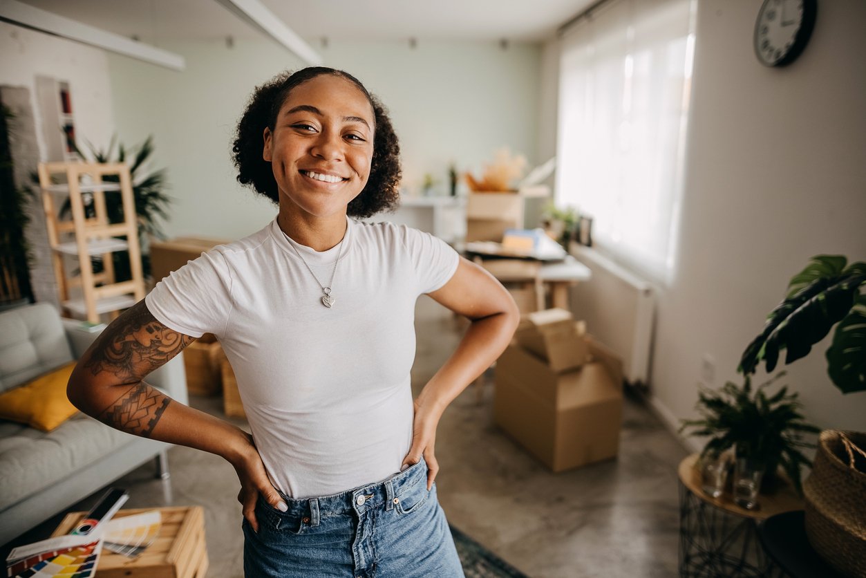 Smiling person in front of their apartment Smiling person in front of their apartment